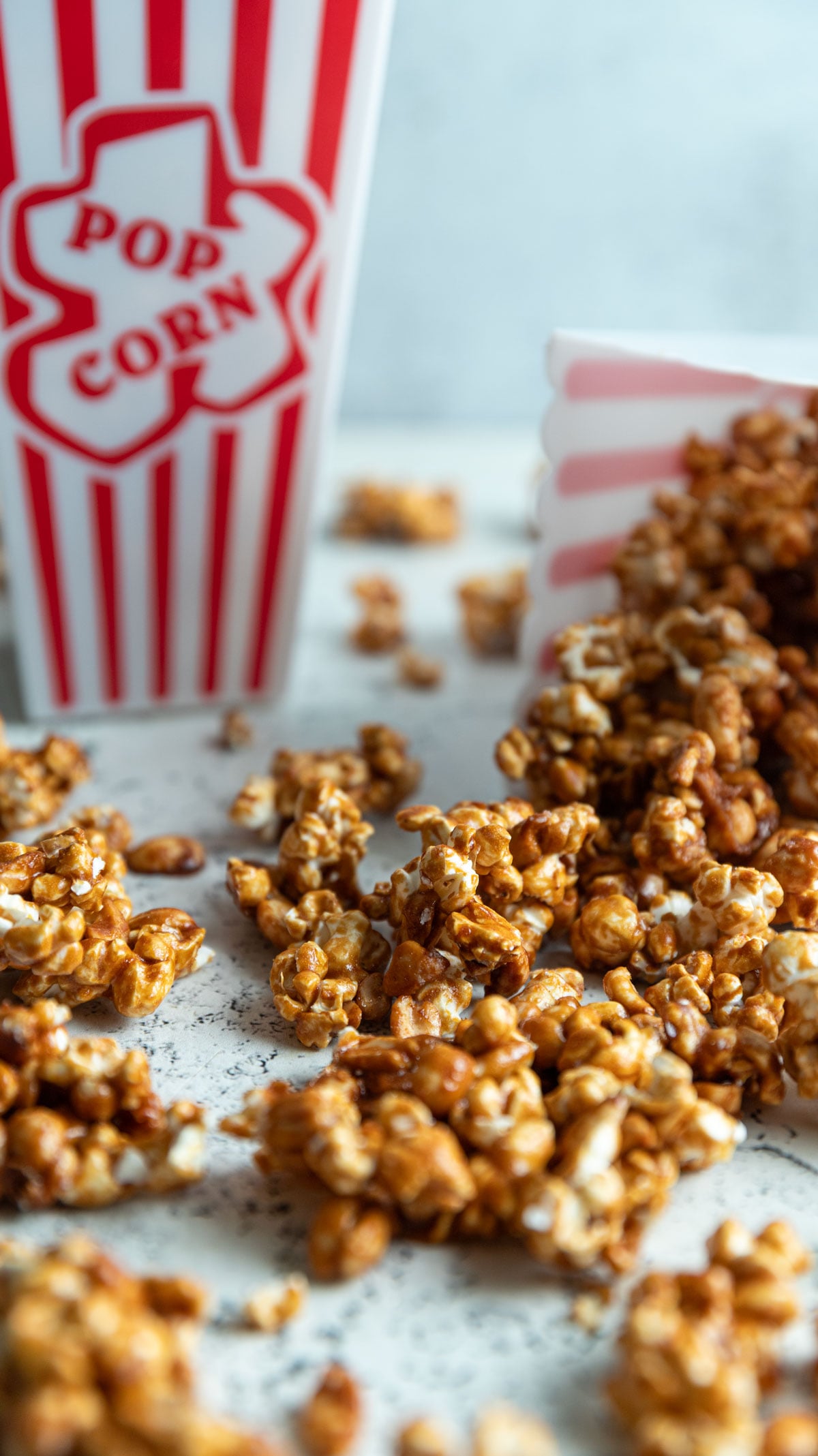 Close up of caramel corn clusters with peanuts.