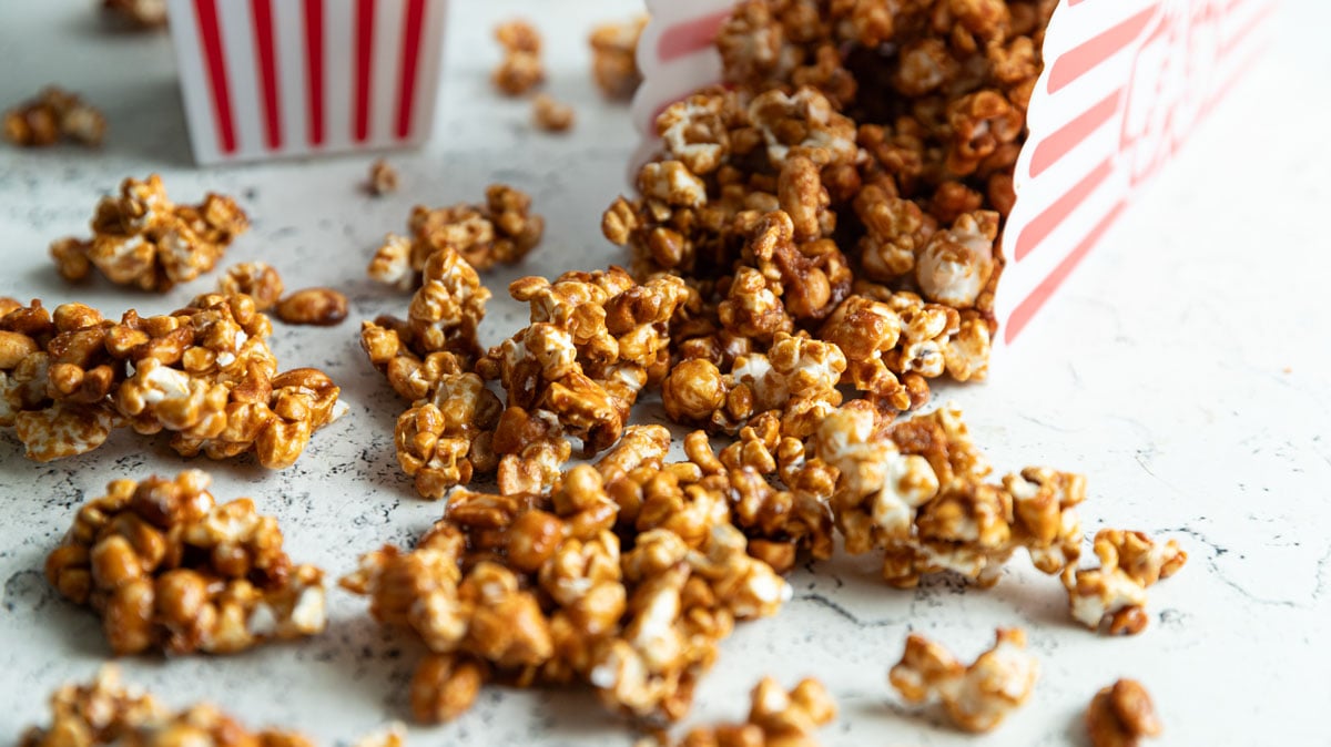 Caramel corn spilling from a popcorn box.