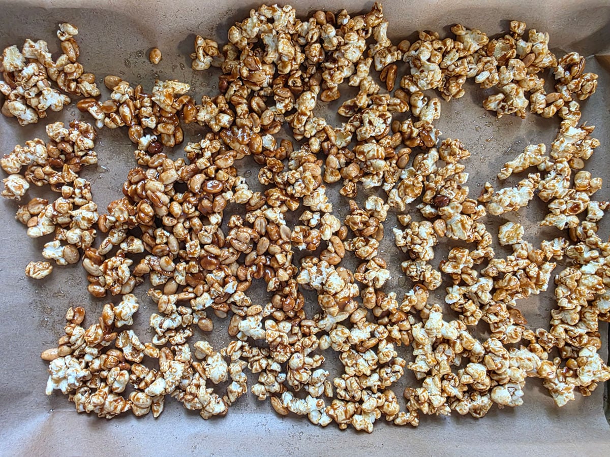 caramel corn spread onto a rimmed baking sheet.