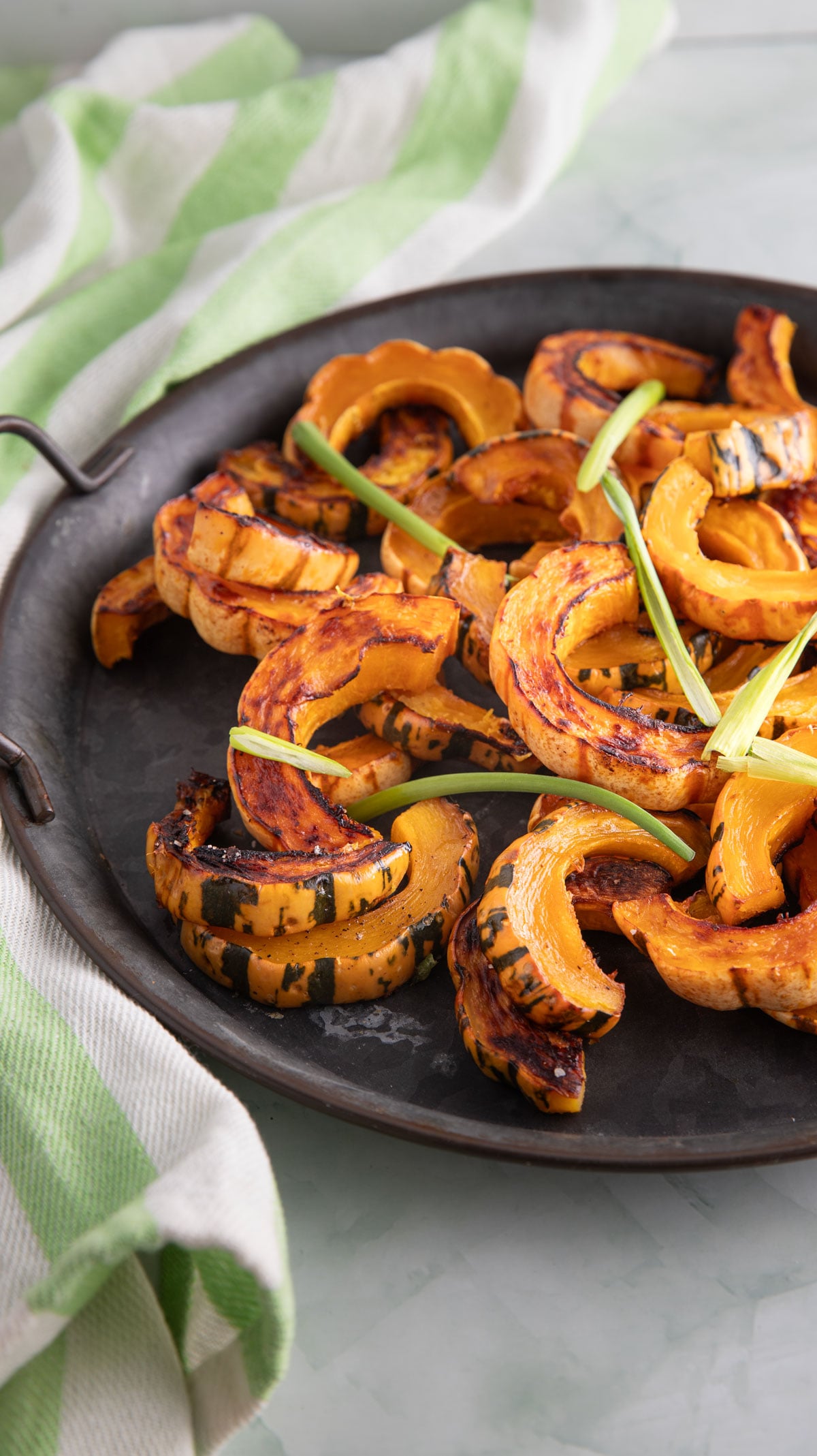 Large platter filled with colorful delicata squash slices.