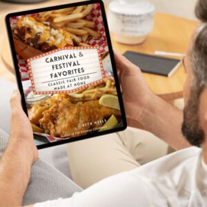 Man holding a tablet with Carnival & Festival Favorites cover page showing.