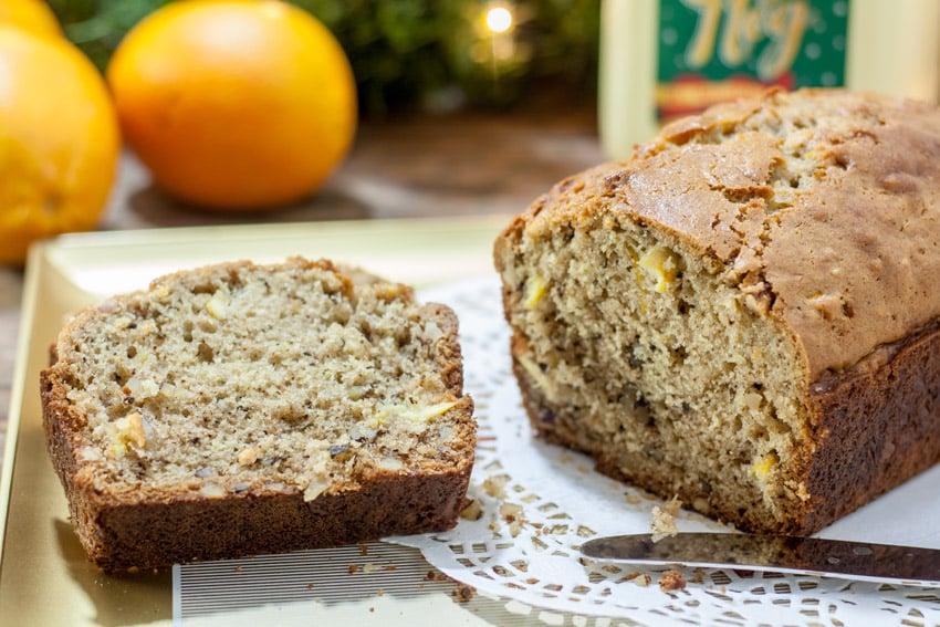 Slices of eggnog bread nest to the whole loaf.