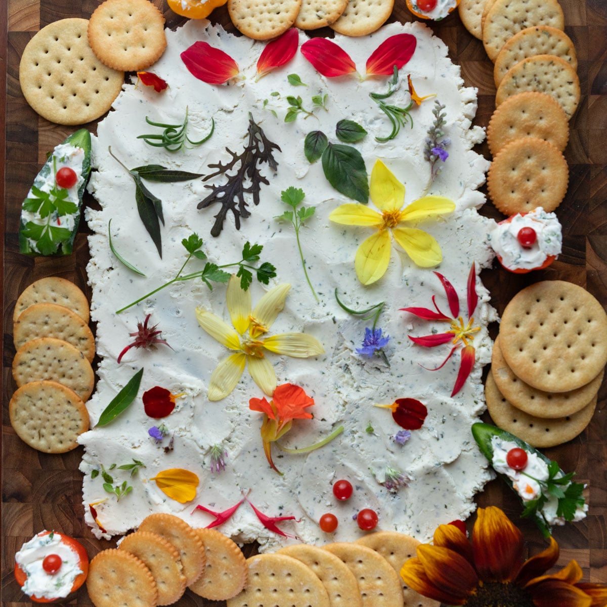 Cream cheese board with edible flowers and herbs.