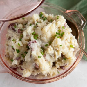 Mashed potatoes with red skins in a pink dish.