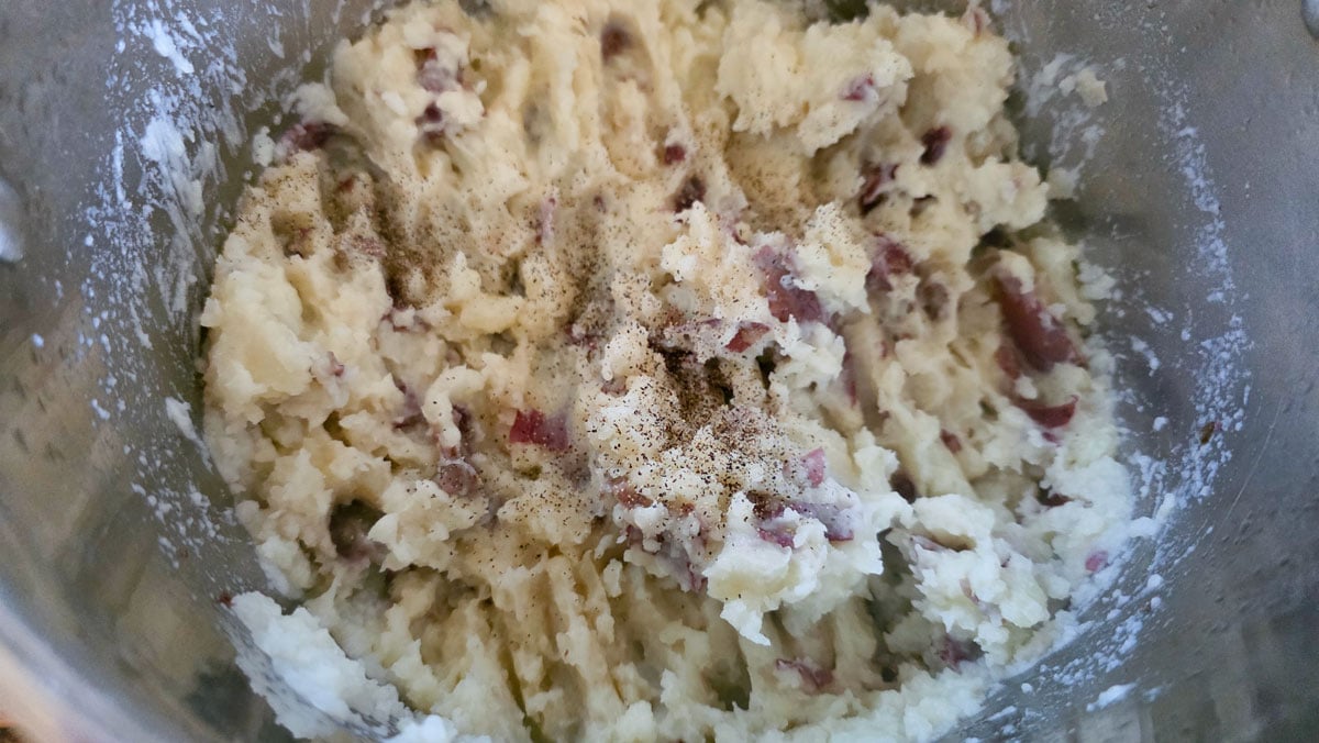 Mashed potatoes with salt and pepper added.