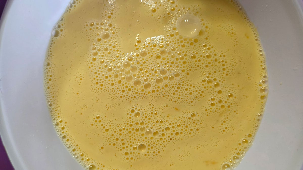 Whisk the eggs, then add the milk.