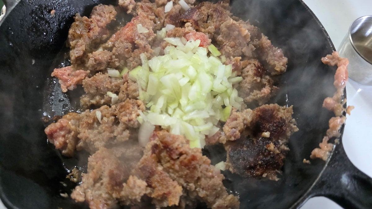 Browning sausage and added onion.